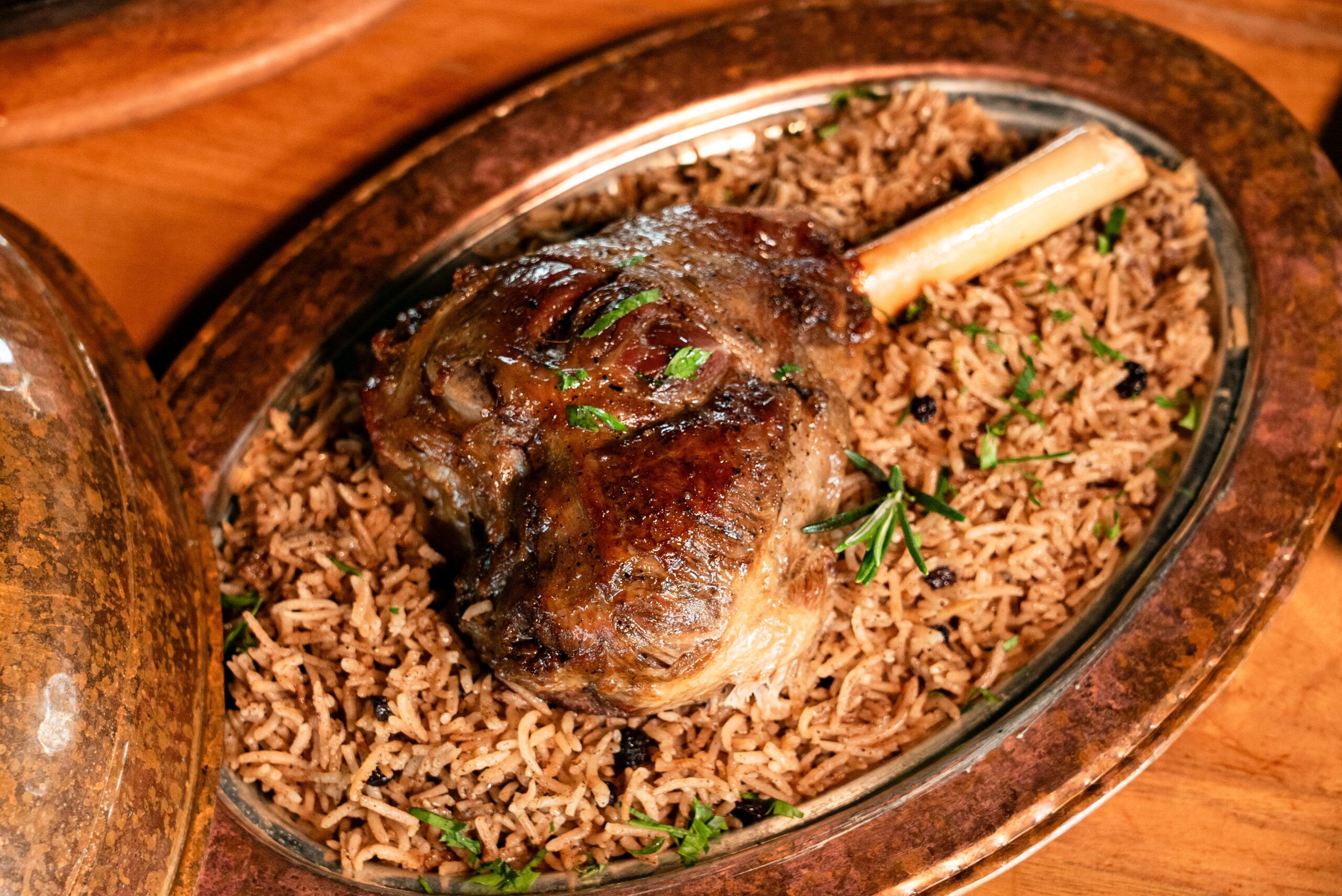 pexels photo 36984980 36984980 1 Juicy lamb shank served on a bed of aromatic spiced rice.